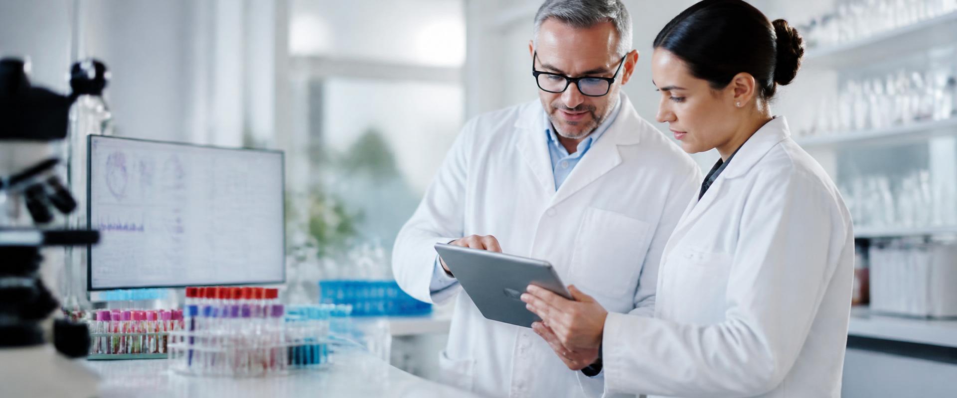 Clinical scientists reviewing validation data in a modern laboratory